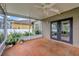 The screened patio offers a ceiling fan and sliding glass doors to the backyard at 1535 Crossvine Ct, Trinity, FL 34655