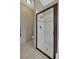 Modern bathroom featuring an enclosed shower with glass door and white tiled walls at 1535 Crossvine Ct, Trinity, FL 34655