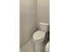 A simple toilet and tile floors create a minimalist and functional space at 1535 Crossvine Ct, Trinity, FL 34655