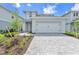 Charming two-story home with a two-car garage and well-manicured front yard at 15853 Elina Sky Dr, Punta Gorda, FL 33982
