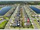 Expansive aerial view of a residential community featuring homes, lakes, and street layout at 16704 Sunburst Lake St, Wimauma, FL 33598