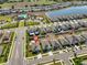 Aerial view of a house in a neighborhood with a community pool at 16704 Sunburst Lake St, Wimauma, FL 33598