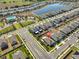 Aerial view of a house in a neighborhood with a community pool at 16704 Sunburst Lake St, Wimauma, FL 33598