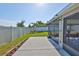 Well-maintained backyard featuring a patio and lush green grass and partial fence at 16704 Sunburst Lake St, Wimauma, FL 33598