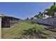 Spacious backyard with screened-in patio and partial fence at 16704 Sunburst Lake St, Wimauma, FL 33598