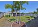 Lush backyard featuring a well-kept lawn, screened patio, and decorative landscaping for relaxed outdoor living at 16704 Sunburst Lake St, Wimauma, FL 33598