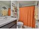 Bright bathroom with patterned shower curtain and decorative shelves at 16704 Sunburst Lake St, Wimauma, FL 33598