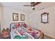 Cozy bedroom with ceiling fan, wall art, and superhero-themed bedding at 16704 Sunburst Lake St, Wimauma, FL 33598