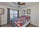 Comfortable bedroom featuring a large window and colorful bedding at 16704 Sunburst Lake St, Wimauma, FL 33598