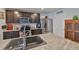 Close up of a Kitchen island with granite countertops, stainless steel appliances, and dark wood cabinetry at 16704 Sunburst Lake St, Wimauma, FL 33598