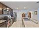Modern kitchen with stainless steel appliances, granite countertops, and dark wood cabinetry at 16704 Sunburst Lake St, Wimauma, FL 33598