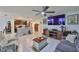 Spacious open-concept living room with a ceiling fan and seamless flow to the kitchen, ideal for modern living at 16704 Sunburst Lake St, Wimauma, FL 33598