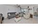 Comfortable living room with neutral decor, featuring tile floors and ample seating, perfect for relaxation at 16704 Sunburst Lake St, Wimauma, FL 33598