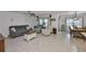 Living room with tile floors, a ceiling fan, and cozy furniture, adjacent to the dining and kitchen areas at 16704 Sunburst Lake St, Wimauma, FL 33598
