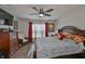 Well-lit main bedroom with hardwood floors, vibrant curtains, and large windows for natural light and comfort at 16704 Sunburst Lake St, Wimauma, FL 33598