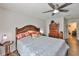 Inviting main bedroom with ceiling fan, wooden accents, and soft natural light creating a serene atmosphere at 16704 Sunburst Lake St, Wimauma, FL 33598