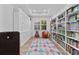 Bright playroom with built-in bookshelves, storage cabinets, window, hardwood floor, and colorful rug at 17731 Bright Wheat Dr, Lithia, FL 33547