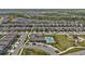 Aerial view of a well-planned community featuring a pool, playground, and green spaces at 18017 Ramble On Way, Land O Lakes, FL 34638