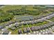 Aerial view of a community with well-maintained homes and a scenic pond in the distance at 18017 Ramble On Way, Land O Lakes, FL 34638
