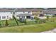Aerial view of a fenced backyard featuring a trampoline, patio seating, and well-manicured lawn at 18017 Ramble On Way, Land O Lakes, FL 34638