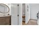 Stylish half bathroom featuring modern vanity with an oval mirror, adding a touch of elegance to the home at 18017 Ramble On Way, Land O Lakes, FL 34638