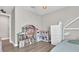 Bright bedroom includes dollhouse and play kitchen, along with a twin bed and closet at 18017 Ramble On Way, Land O Lakes, FL 34638