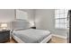 Cozy bedroom featuring a queen bed, bedside tables with lamps and light wood flooring at 18017 Ramble On Way, Land O Lakes, FL 34638