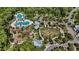 Aerial view of a fantastic community pool area with mature trees, and plentiful seating at 18017 Ramble On Way, Land O Lakes, FL 34638