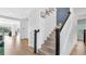 Bright entryway with hardwood floors, staircase with wooden handrail, and neutral paint at 18017 Ramble On Way, Land O Lakes, FL 34638