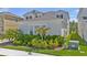 Lush landscaping adds natural beauty to this home's exterior, complete with privacy fence in the background at 18017 Ramble On Way, Land O Lakes, FL 34638