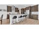 Open kitchen with a large island, stainless steel appliances, and dark wood cabinets at 18017 Ramble On Way, Land O Lakes, FL 34638
