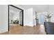 Bright open-concept living room with hardwood floors, leading to the entryway and other rooms at 18017 Ramble On Way, Land O Lakes, FL 34638