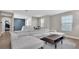 Comfortable living room with a large sectional sofa, stylish coffee table, and neutral color palette at 18017 Ramble On Way, Land O Lakes, FL 34638