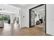 Bright open-concept living room with hardwood floors flowing into adjacent rooms, perfect for entertaining at 18017 Ramble On Way, Land O Lakes, FL 34638