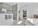 Bright main bathroom features separate shower and soaking tub with tile accents at 18017 Ramble On Way, Land O Lakes, FL 34638