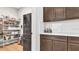 Walk-in pantry with shelving, cabinets and stainless steel refrigerator at 18017 Ramble On Way, Land O Lakes, FL 34638