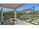 Covered patio features hot tub, ceiling fan, outdoor furniture, and view of a lake at 18017 Ramble On Way, Land O Lakes, FL 34638