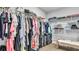 Walk-in closet features built-in shelving with clothing, bags, and luggage at 18017 Ramble On Way, Land O Lakes, FL 34638