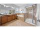Bathroom featuring double vanity, soaking tub, and glass-enclosed shower at 18677 Milton Keynes Ct, Land O Lakes, FL 34638