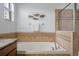 Bathroom featuring soaking tub with tile surround and decor at 18677 Milton Keynes Ct, Land O Lakes, FL 34638