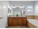 Bathroom with double vanity and soaking tub at 18677 Milton Keynes Ct, Land O Lakes, FL 34638