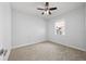 Neutral bedroom with carpet, ceiling fan and bright window at 18677 Milton Keynes Ct, Land O Lakes, FL 34638