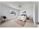 Inviting bedroom featuring a comfortable bed, soft carpet, ceiling fan, and natural light for a restful retreat at 18677 Milton Keynes Ct, Land O Lakes, FL 34638