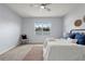 Serene bedroom with a large window, neutral walls, and plush carpet, providing a comfortable, relaxing atmosphere at 18677 Milton Keynes Ct, Land O Lakes, FL 34638