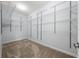 Walk-in closet with installed shelving system at 18677 Milton Keynes Ct, Land O Lakes, FL 34638
