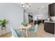 Cozy dining area connects seamlessly to kitchen, enhancing open floor plan, featuring stylish table setting at 18677 Milton Keynes Ct, Land O Lakes, FL 34638