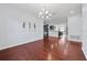 Open concept dining room with hardwood floors that connects to the living room and kitchen at 18677 Milton Keynes Ct, Land O Lakes, FL 34638