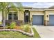 Charming single-story home featuring stone accents, a two-car garage, and beautifully landscaped front yard at 18677 Milton Keynes Ct, Land O Lakes, FL 34638