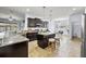 Well-equipped kitchen with granite counters, an island with seating, dark wood cabinets and stainless appliances at 18677 Milton Keynes Ct, Land O Lakes, FL 34638