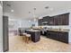 Open kitchen boasts stainless appliances, dark cabinetry, granite countertops, and a central island with seating at 18677 Milton Keynes Ct, Land O Lakes, FL 34638
